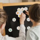 Enfants jouant au jeu de phonologie voyelles La Ruche des sons sur tableau magnétique